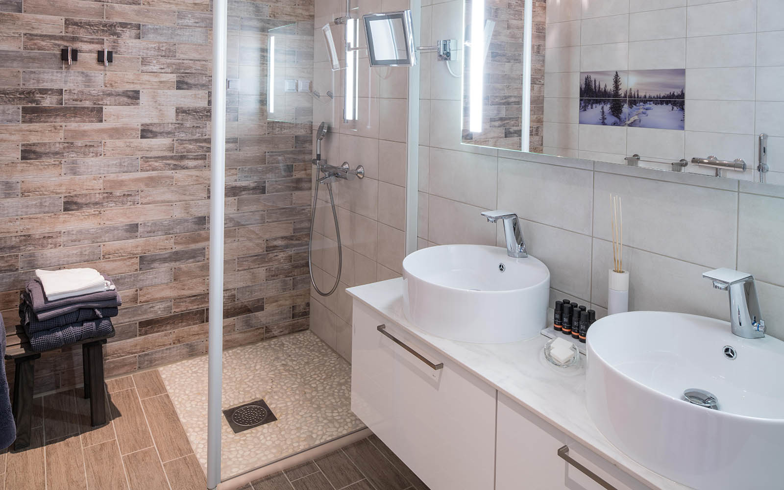 A luxurious bathroom suite with walk in shower and twin vanity in the spacious Suite Hotel Rooms at Hotel Yllas Humina, Lapland