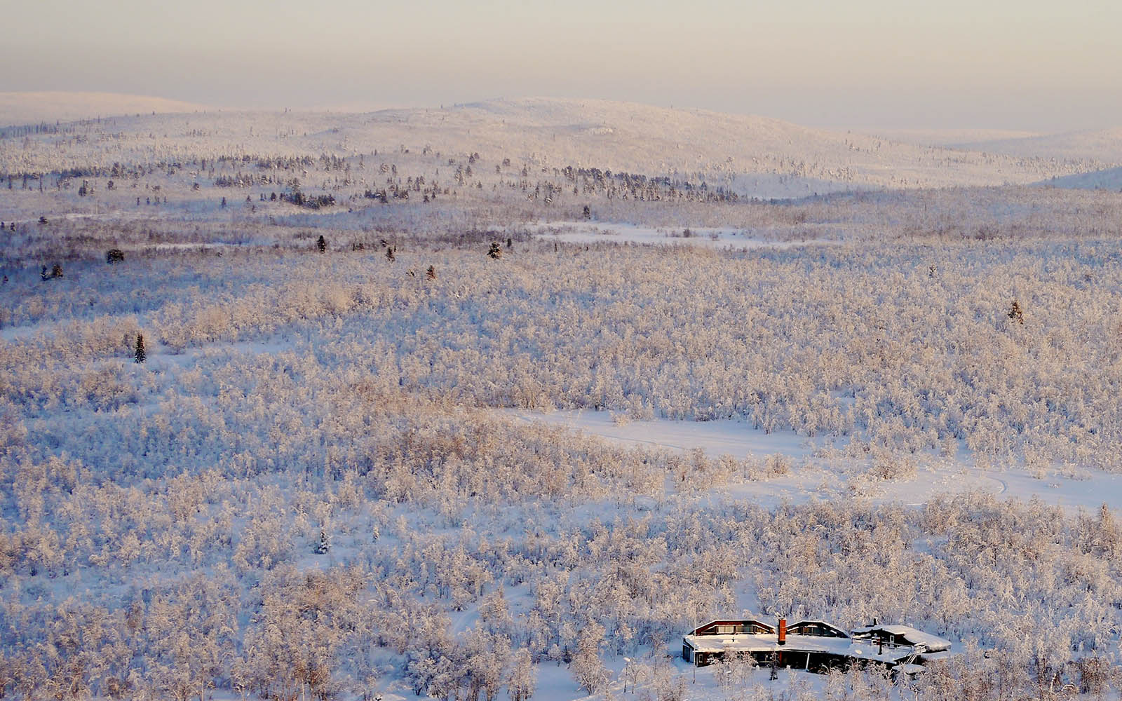 An aerial view of the secluded setting of Máttaráhkká Northern Light Lodge on the edge of Kiruna, Swedish Lapland 