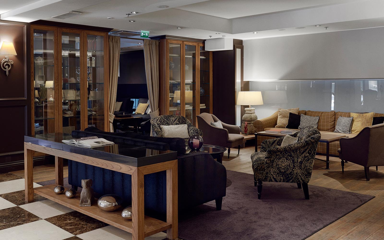 The hotel lobby at Haven Hotel in Helsinki, Finland with a console table separating the comfortable seating area