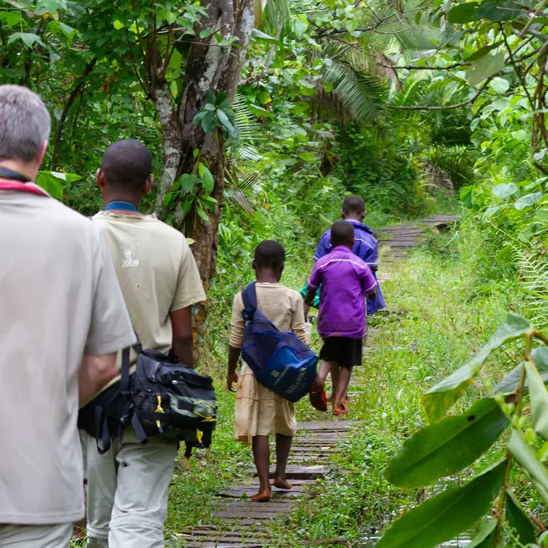 Birdwatching walk in Bigodi Wetland Sanctuary with local children; photograph taken on birdwatching safari in Uganda - Wildlife & Wilderness