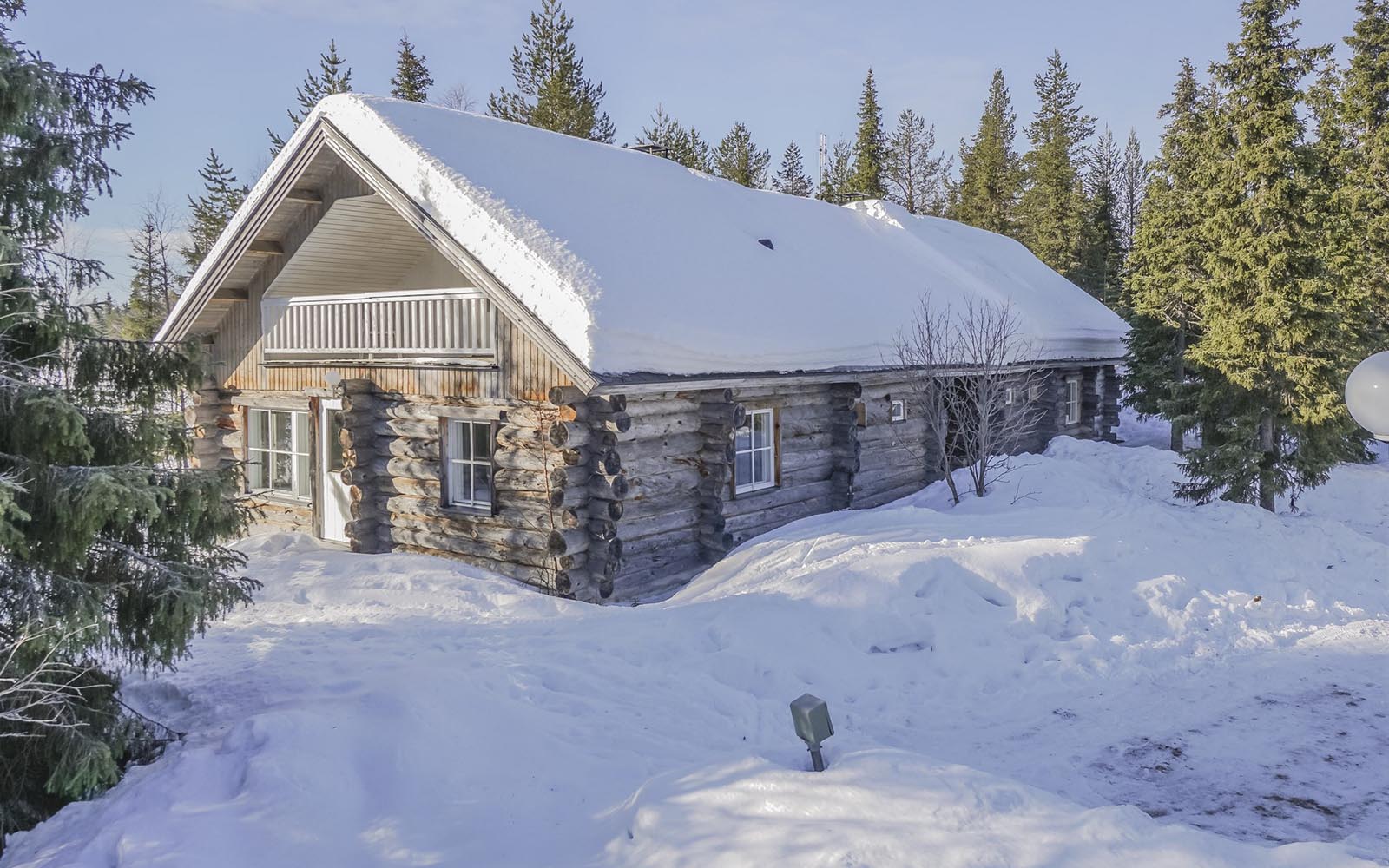 Villa Rukan Huurre, constructed with barkless pine logs sits in the snow at Iisakki Village near Ruka in Finland