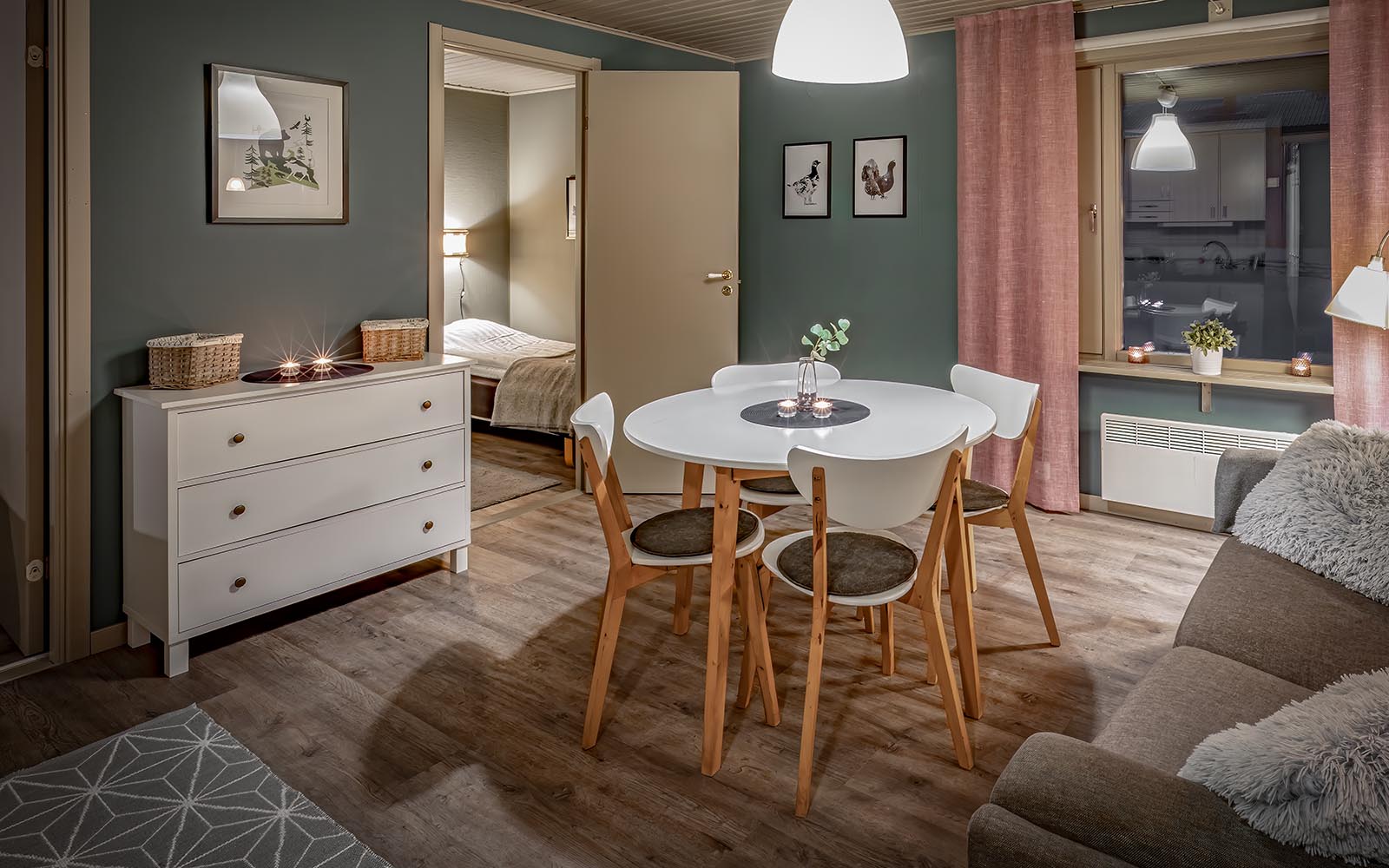 A small round dining table sits at the centre of the lounge in the cabins at Brandon Lodge near Lulea, Sweden