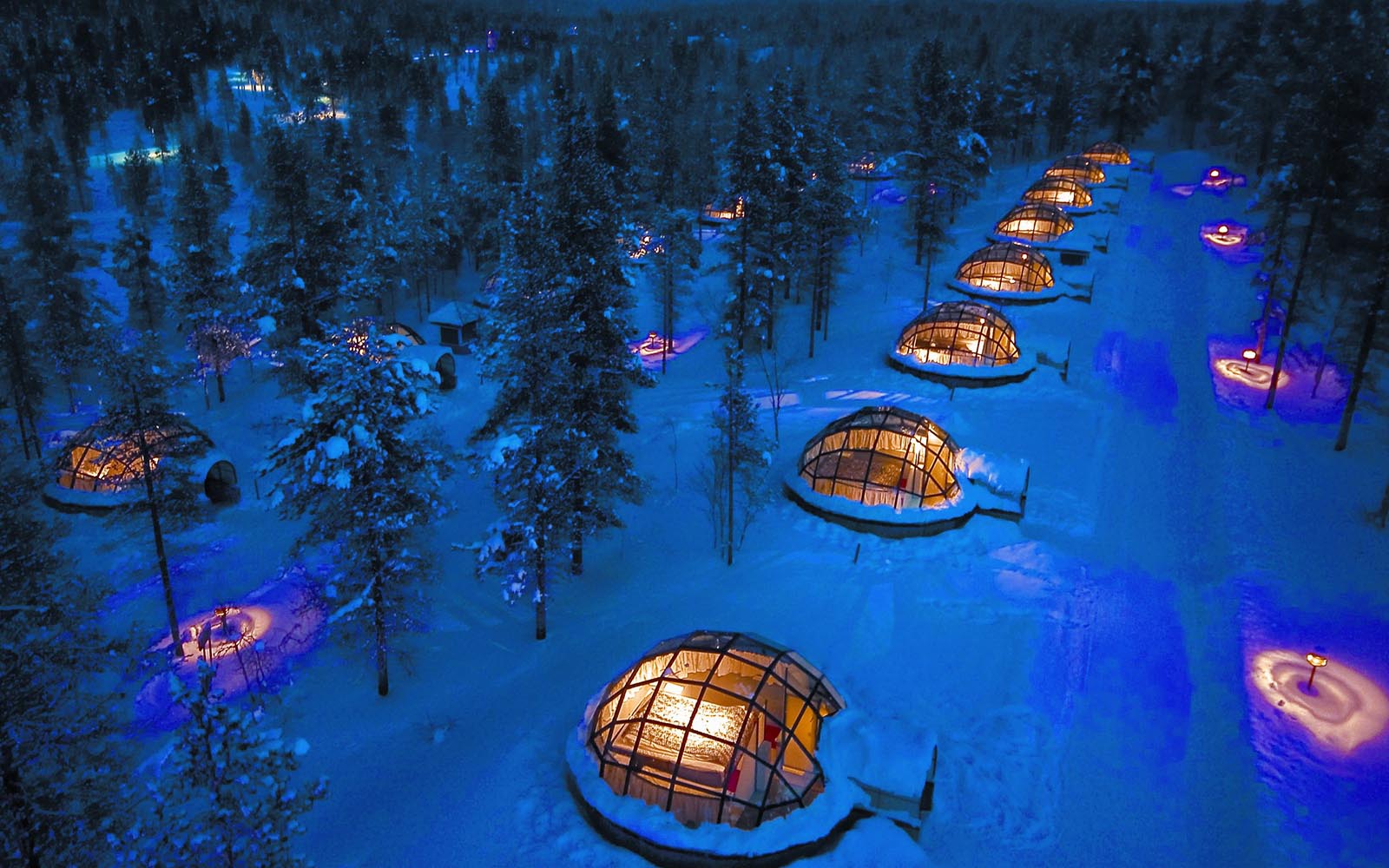 An aerial night time shot of the famous glass igloos at at Kakslauttanen Resort in northern Lapland, Finland, a bucket list destination