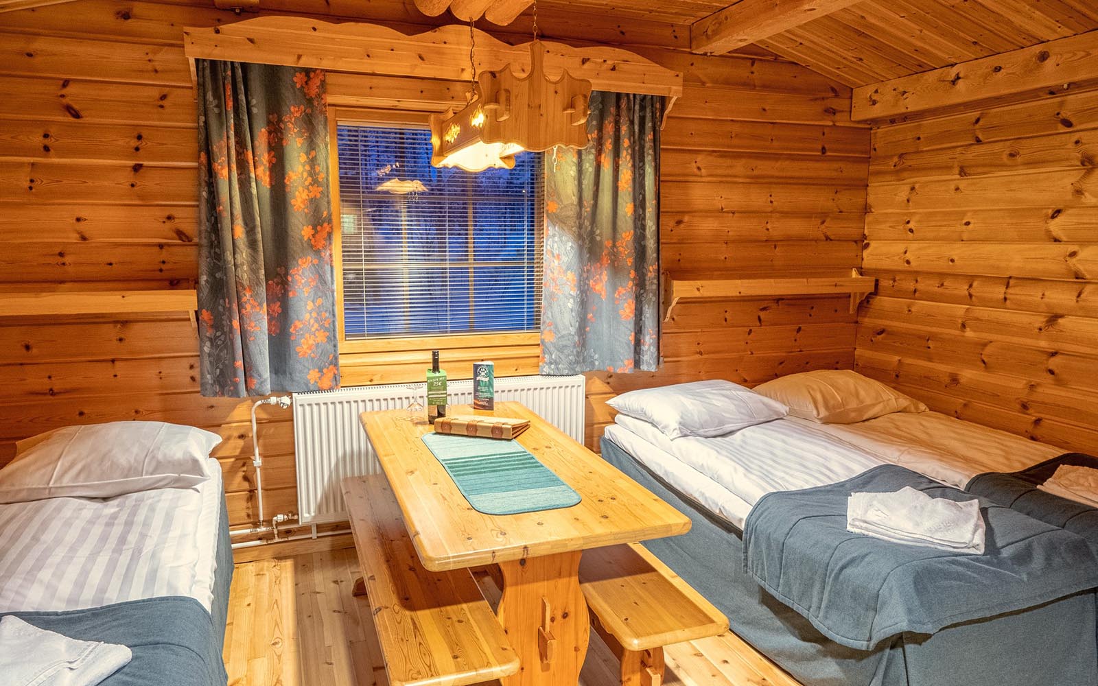 A pine clad Standard Room at Harriniva Adventure Resort near Muonio in Finnish Lapland sleeps up to 3 people