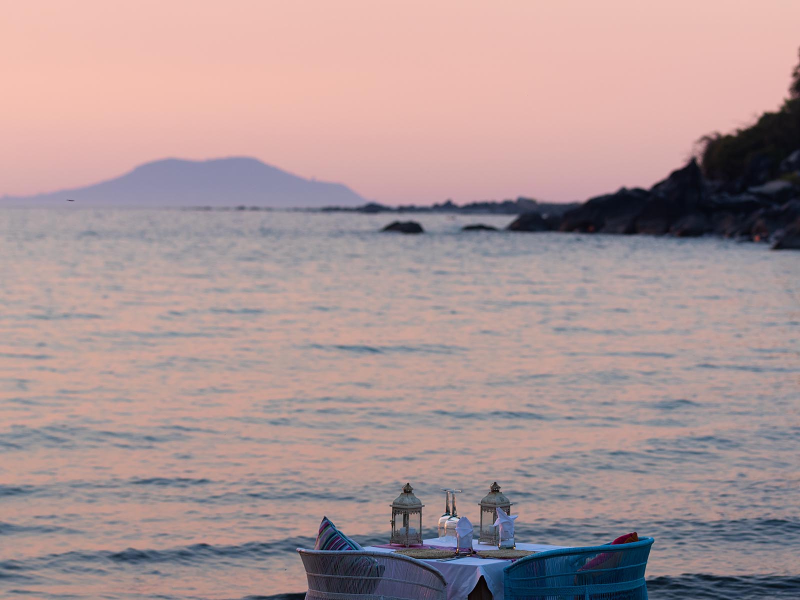 Sunset view across a table for two beside Lake Malawi at Kaya Mawa, Likoma Island; photograph taken from the beach - Wildlife & Wilderness