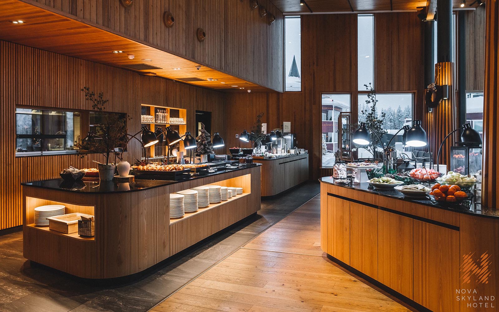 A pine clad buffet table laden with tasty Lappish dishes awaits the hungry guests in the restaurant at Nova Skyland on the edge of Santa Claus Village in Finnish Lapland 