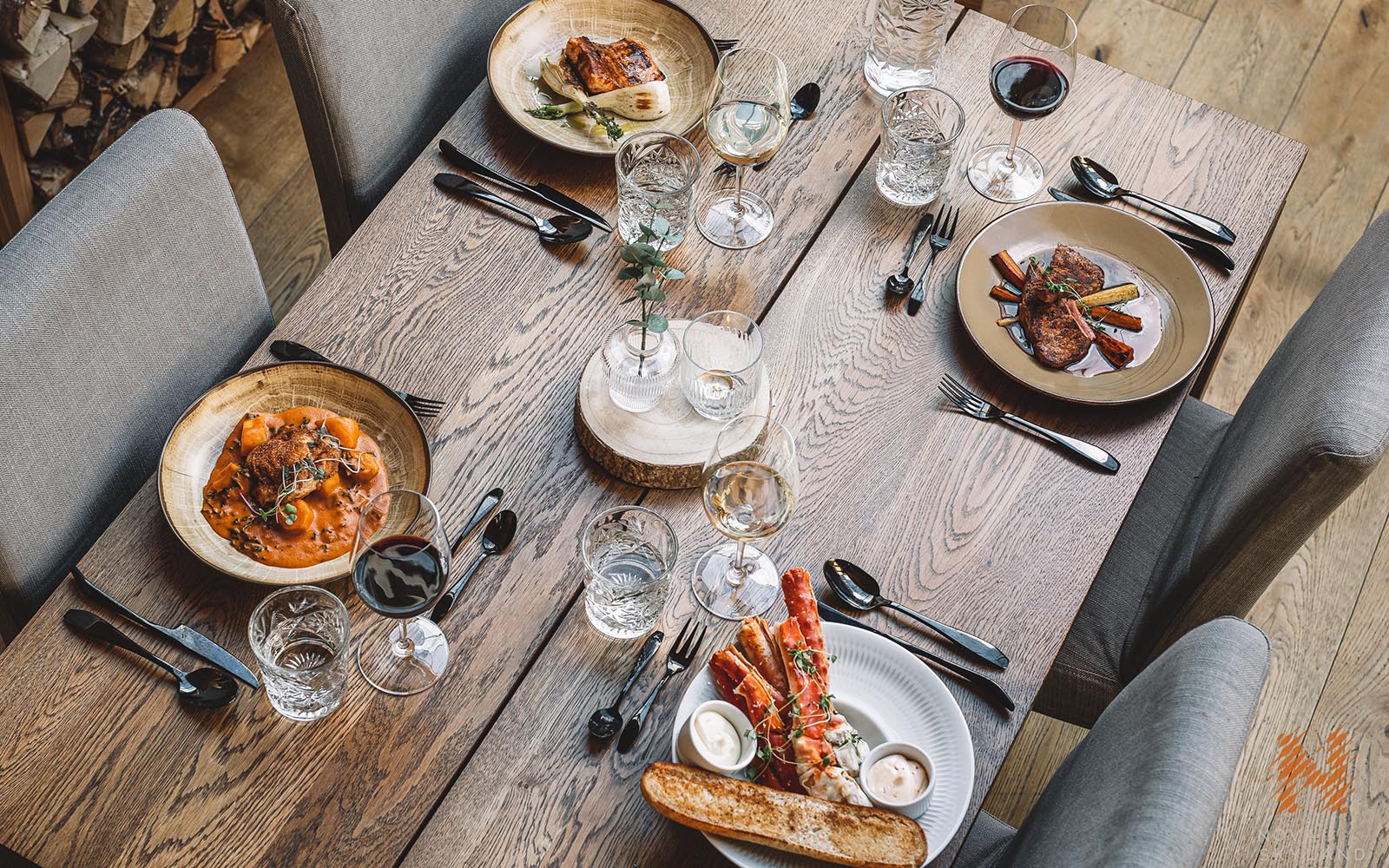 A selection of tasty looking Lappish starters is served at a wooden dining table in the restaurant at Nova Skyland in Rovaniemi, Finnish Lapland