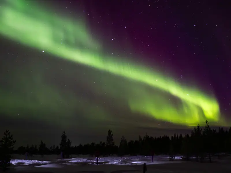 Green auroras above a lake in Yllas, Finland